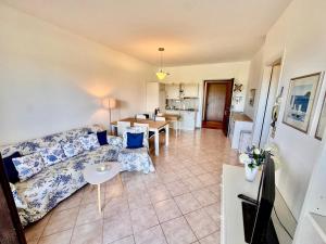 a living room with a couch and a table at Residence agli Oleandri in Manerba del Garda