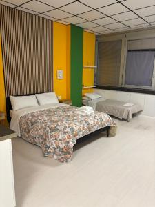 a bedroom with two beds and colorful walls at Loft 80 in Castel Maggiore