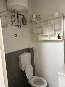 a white bathroom with a toilet and a sink at Loft 80 in Castel Maggiore