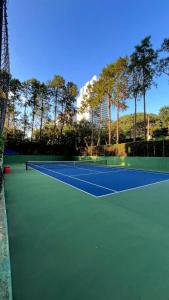 a tennis court with two tennis at Alphaville Serviced Apartment São Paulo in Barueri