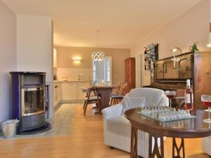 a kitchen and living room with a table and a fireplace at Landhaus Victoria in Boltenhagen
