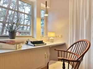 a room with a desk with a chair and a window at Landhaus Victoria in Boltenhagen