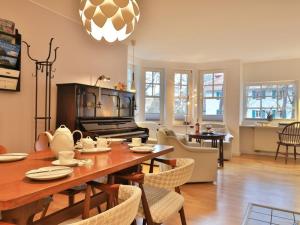 a dining room and living room with a table and chairs at Landhaus Victoria in Boltenhagen +35 photos