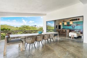 a kitchen and dining room with a large table and chairs at Vista Alegre by Boutique Bonaire Unique Resorts in Kralendijk