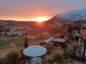 a sunset over a city with a gazebo at B&B La Francesina in Lanzo Torinese