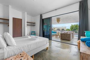 a bedroom with a bed and a balcony at Vista Alegre by Boutique Bonaire Unique Resorts in Kralendijk