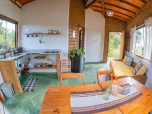 a living room with a couch and a table at Sítio Embaú in Carrancas