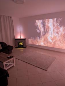 a living room with a large painting on the wall at Google Smart Home Unterkunft - 1 in Kenn