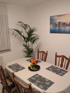 a dining room table with a plate of fruit on it at Google Smart Home Unterkunft - 1 in Kenn