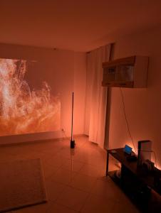 a living room with a painting on the wall at Google Smart Home Unterkunft - 1 in Kenn