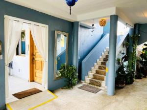a hallway with a staircase and a blue wall at Casa Punta Perula Boutique Hotel in Pérula