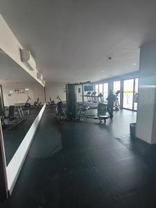 a gym with several treadmills and exercise bikes in it at Buyan Departamentos in Mérida