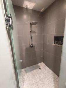 a shower with a glass door in a bathroom at Buyan Departamentos in Mérida +8 photos