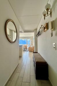 a hallway with a mirror and a couch in a room at Ferienwohnung C15 in Orselina +18 photos