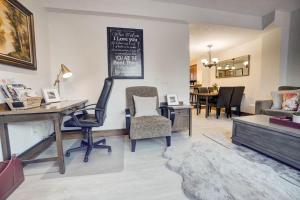 a living room with a desk and chairs and a table at Fire Mountain 204 2 Level, 2 bed, great views! in Canmore