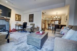 a living room with a couch and a table at Fire Mountain 204 2 Level, 2 bed, great views! in Canmore