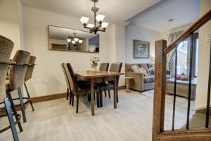 a dining room and living room with a table and chairs at Fire Mountain 204 2 Level, 2 bed, great views! in Canmore +25 photos