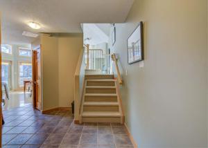 a stairway in a home with a stair case at 212 Alpine Village Spacious 2Bed-2Bath-Mtn Views! in Canmore