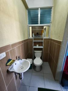 a bathroom with a sink and a toilet and a window at GuateDo Atitlán Loft & Rooftop in Panajachel