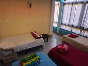 a hospital room with two beds and a window at GuateDo Atitlán Loft & Rooftop in Panajachel