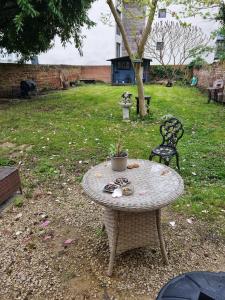 a table with a potted plant on it in a yard at Spalite Hotel in Gloucester