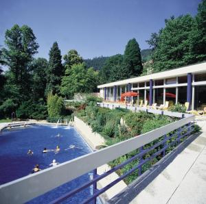 a group of people swimming in a pool at a hotel at Hotel Bergfrieden in Bad Wildbad