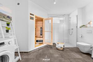 a white bathroom with a toilet and a shower at Ferienwohnung Albatros Olpenitz in Olpenitz