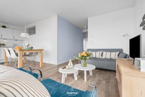 a living room with a couch and a table at Ferienwohnung Albatros Olpenitz in Olpenitz +24 photos