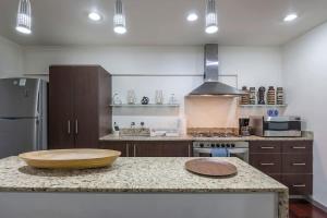 a kitchen with a wooden bowl on top of a counter at Chic 2BR Condo in Condesa steps from Parque Mexico in Mexico City