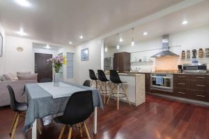 a kitchen and living room with a table and chairs at Chic 2BR Condo in Condesa steps from Parque Mexico in Mexico City