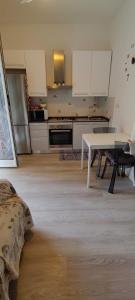a kitchen with a white table and a white counter top at Casa Martina in Cogoleto