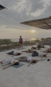a group of people doing yoga on the beach at Selvamar Hermosa in Playa Hermosa