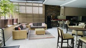 a living room with a couch and chairs and tables at Studio apartment in downtown Joinville, SC in Joinville
