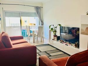 a living room with a couch and a fish tank at Renaissance sunrises inn in Portimão