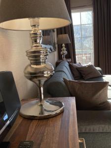 a lamp on a table in a living room at Luxus Ferienwohnung schöne Aussicht in Hahnenklee-Bockswiese