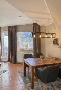 a dining room with a wooden table and chairs at Luxus Ferienwohnung schöne Aussicht in Hahnenklee-Bockswiese