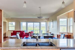 a kitchen with a sink and a living room at Lakeside Haven in Rockaway Beach