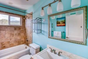 a bathroom with a tub and a sink and a mirror at Lakeside Haven in Rockaway Beach +57 photos