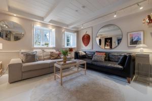 a living room with a couch and a table at Inselidyll Alter Friesenhof in Süderende