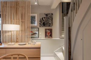 a room with a desk and a zebra picture on the wall at Inselidyll Alter Friesenhof in Süderende +68 photos