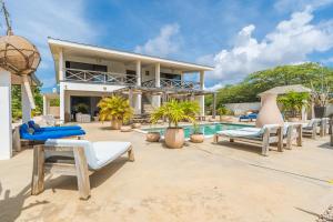 a villa with a swimming pool and a resort at Vista Alegre by Boutique Bonaire Unique Resorts in Kralendijk