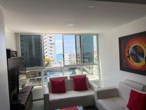 a living room with a couch and a large window at Kattyapartament 303 Salinas in Salinas