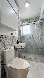 a bathroom with a toilet and a sink and a shower at Comodidades, modernidad, céntrico in Caracas