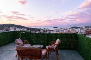 two chairs and a table on a balcony with a view at Vila Myrtaj in Ksamil