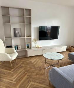 a living room with a tv and a table at SILVER apartment - Rezidencia Bojnice in Bojnice