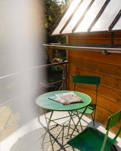 a green table and two chairs on a balcony at Chata Jánošík in Terchová