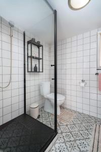 a bathroom with a toilet and a glass shower door at Chata Jánošík in Terchová