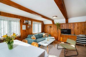 a living room with a couch and a table at Chata Jánošík in Terchová
