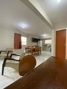 a dining room and living room with a table and chairs at Ed The Rock in Belém