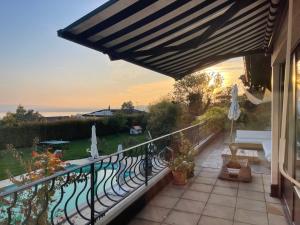 a balcony with a view of a swimming pool at Alps and Lakeview Villa with Pool in Haut-Vully